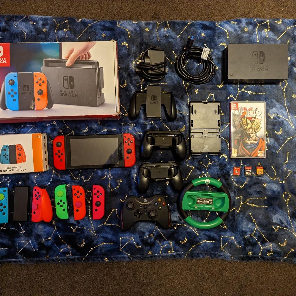 Large switch bundle. This is the mario odyssey edition with the rare limited edition deep red mario joycons, it is also gen 1 unmodded. Comes boxed with all standard items (dock, charge cable, hdmi and handgrip). Also comes with 3x spare official joycons and 2x 3rd party joycons with a handgrip. Includes 2x official controller holders, a wired controller (missing the wire), a Luigi wheel controller and a Nintendo angled stand. Games included are Dragonball xenoverse (boxed) and mario odyssey and captain toad (unboxed). Collection or delivery at buyers cost. Offers accepted on multiple items.
