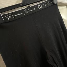 Black leggings with white writing river island design on elasticated waist band with design front and back. Please take a look at my other items.