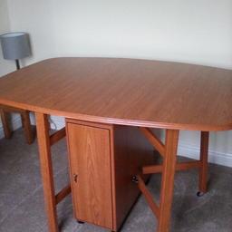 Drop leaf folding dining table, can be tucked away for space. Storage cupboards either side, legs on casters for easy manoeuvres. 
Some marks (shown in pictures)