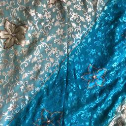 Blue / Yellow Saree. Simple , lightweight & elegant. Worn once. Half saree is blue with sequenced flower motifs. The other half of saree is the floral yellow & blue small flower pattern .