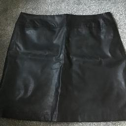 Black mini leather skirt. Brand new with tag still. Size 14. Size split at bottom …