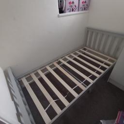 grey single wooden bed frame.