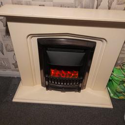 Cream fire place with electric fire in it which is in good working condition and let's off a good amount of heat and flames that show when turned on