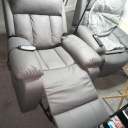 2 leatherette light grey electric reclining arm chairs 1 is manual recline other electric both have heat and massage functions very good condition hardly used £300 for the two collection only