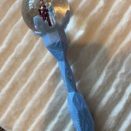 Battery operated musical frozen snow globe wand.