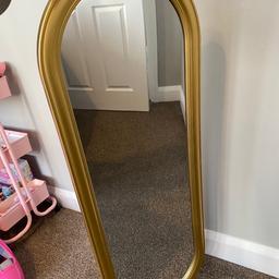 Gold oval shaped mirror.