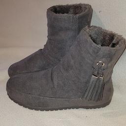 Grey Faux Fur Lined Ugg style Snow Boots with tassels Barely worn condition uk5. See photos for condition and size. I can offer try before you buy option but if viewing on an auction site viewing STRICTLY prior to end of auction.  If you bid and win it's yours. Cash on collection or post at extra cost which is £4.55 Royal Mail 2nd class signed for. I can offer free local delivery within five miles of my postcode which is LS104NF. Listed on five other sites so it may end abruptly. Don't be disappointed. Any questions please ask and I will answer asap.