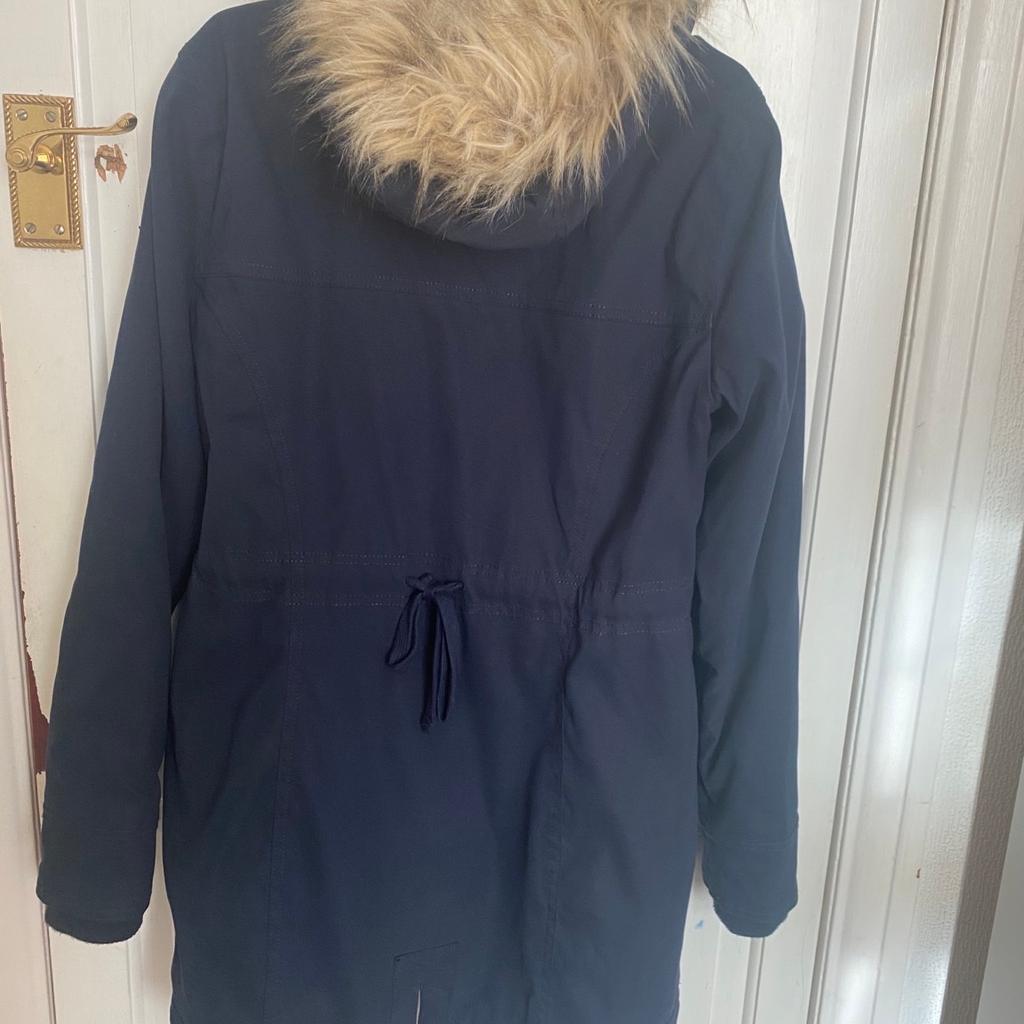 Beautiful navy winter parka, perfect for any cold weathers. Detachable Fur on hood. Lined with This classic parka features cozy faux fur lining, full zipper closure with buttons and front pockets. Storm cuffs, heavier weight construction. Only worn once and in very good condition.