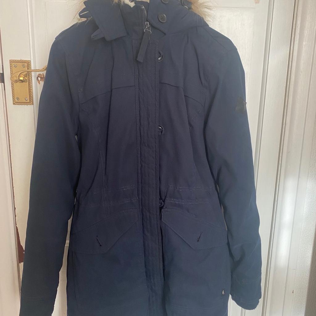 Beautiful navy winter parka, perfect for any cold weathers. Detachable Fur on hood. Lined with This classic parka features cozy faux fur lining, full zipper closure with buttons and front pockets. Storm cuffs, heavier weight construction. Only worn once and in very good condition.