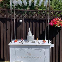 Gorgeous Champagne/ Prosseco Cart for hire
Great addition to your wedding or to any party, very popular for Birthdays, Engagement parties, Baby Showers etc
Price includes 42 flutes

Please contact us to check availability and area we cover before you place an order

This is for HIRE ONLY

Prices from £75 for cart only with flutes.
£120 for the package with balloons.

Price includes free delivery, set up and collection following day within 15 miles of Ng10.

Our Cart are excellent quality and will make your event memorable.

Please note I have lots of items for hire

Large 4ft light up Mr & Mrs and Love letters,
Large hooped wedding cake stand,
Cherry Blossom centrepiece trees,
Sweet cart,
Champagne cart,
5ft wishing tree ,
2 different Vintage post boxes,
Confetti stand and roses trees,
3 different Easels with personalised board or mirror
Donut wall
Shot Wall
Prosecco ladder
Flower walls
Shimmer walls
Balloon hoop or balloon arch. 
Discount packages available.