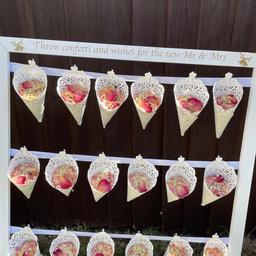 Fabulous confetti stand, with the saying
Throw Confetti and Wishes for the New Mr and Mrs. (Available in silver or gold print)
Each stand holds 18 confetti cones filled with dry rose petals.
Team it up with our beautiful Rose Trees at only £10 more for both trees
Free local delivery within 10miles.
Any questions please feel free to ask, more than happy to help.


Please note I have lots of items for hire

Large 4ft light up Mr & Mrs and Love letters,
Large hooped wedding cake stand,
Cherry Blossom centrepiece trees,
Sweet cart,
Champagne cart,
5ft wishing tree ,
2 different Vintage post boxes,
Confetti stand and roses trees,
3 different Easels with personalised board or mirror
Donut wall
Shot Wall
Prosecco ladder
Flower walls
Shimmer walls
Balloon hoop or balloon arch. Photos and prices on demand.
HAPPY TO OFFER PACKAGES PLEASE FEEL TO MESSAGE FOR AVAILABILITY AND PRICES.