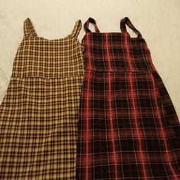 2 New Look girls pinafore dresses. Age 10 to 11. One is red and black tartan. One is mustard and black tartan. 30 inches long. As new. Price is for both. Collection only.