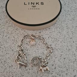 Womens links of London bracelet. the dog +cupcake charm are real. aeroplane ✈️ just added..
feel free to ask any questions..comes with original box 📦 .
