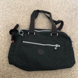 Hardly used Kipling bag in  a slightly domed shape  with front zip pocket and Velcro fastening pocket behind the zip pocket. Has two small storage areas at the side of the bag.  The interior of the bag has a mobile phone pocket with a additional small pocket & a zipped pocket. Also has a key fob in the interior of the bag,
Bag length = 14.5 ins
Bag width = 9.5 ins
Bag depth = 3.5 ins
Bag handle length = 20 ins 
Still in excellent condition