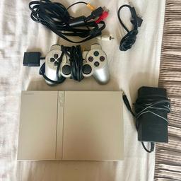 PLAYSTATION 2 SLIM - SILVER . used but fully working PS2 slim, comes with original controller,
memory cards and an adapter to allow 4 controllers to be attached at once.
Any questions please ask