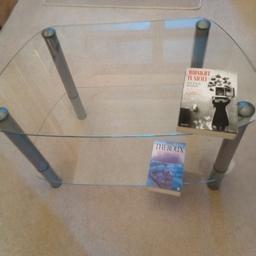 Glass TV table with gray aluminium legs. Single lower shelf.H 47cm. W 76cm reducing to 50cm
D 46cm Shelf height 15cm Gap 30cmExcellent condition.Fixed price please.