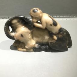 A small hand carved figure of a monkey rideing on back of a long horned water buffaloe  seems monkey whispering into buffaloes ear? Ideal for collector detailed carving either sand stone? Or  type of hard stone? Questions answered size tadge  over 3 inches inches long x 2  and a quarter inches hight