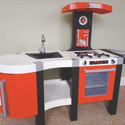 Smoby play kitchen. Very good condition in excellent working order. 
Hob makes a cooking sound when you put the pan on top. Including you food and kitchen utensils. Cost over £110.
