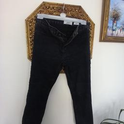 A pair of  distressed black skinny jeans 14