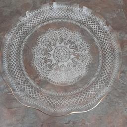 Gorgeous and real quality Vintage Round Glass Serving Platter. Immaculate Undamaged Condition, hardly used considering age from early 60s era. Most of its life on display in a glass cabinet. Fluted edge with gold trim, white delicate doyley like design in glass. Diameter 9.5 inches. Looks stunning at an afternoon tea table or a party with cakes/sandwiches or other party food. From smoke and pet free home. Check out my other items. Happy to combine postage for multiple purchases or collection from DL5 Thanks for looking.