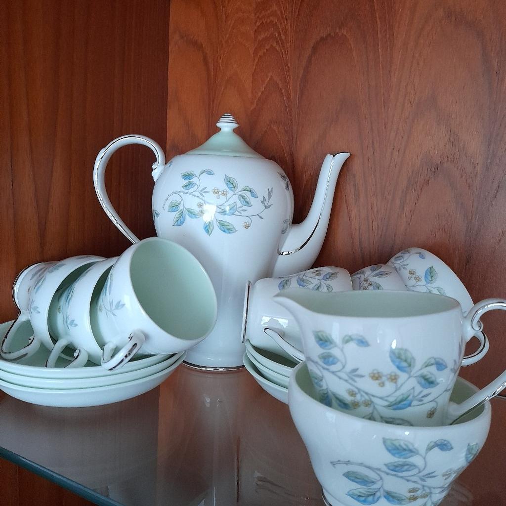 Vintage Royal Grafton Bone China Complete Coffee Set Immaculate Hardly Used Condition. 15 items, coffee pot with lid, cream/milk Jug, sugar bowl, 6 coffee cups and 6 saucers. White with silver trim, delicate blue green and silver floral/leaf decoration and pale green interiors. Absolutely gorgeous. Was a wedding present to my parents in 1962, family never big coffee drinkers hence the fabulous condition. Spent most of its life unused in a glass display cabinet. From smoke and pet free home. Check out my other items. Collection from DL5 only please due to risk of damage in transit. Thanks for looking.