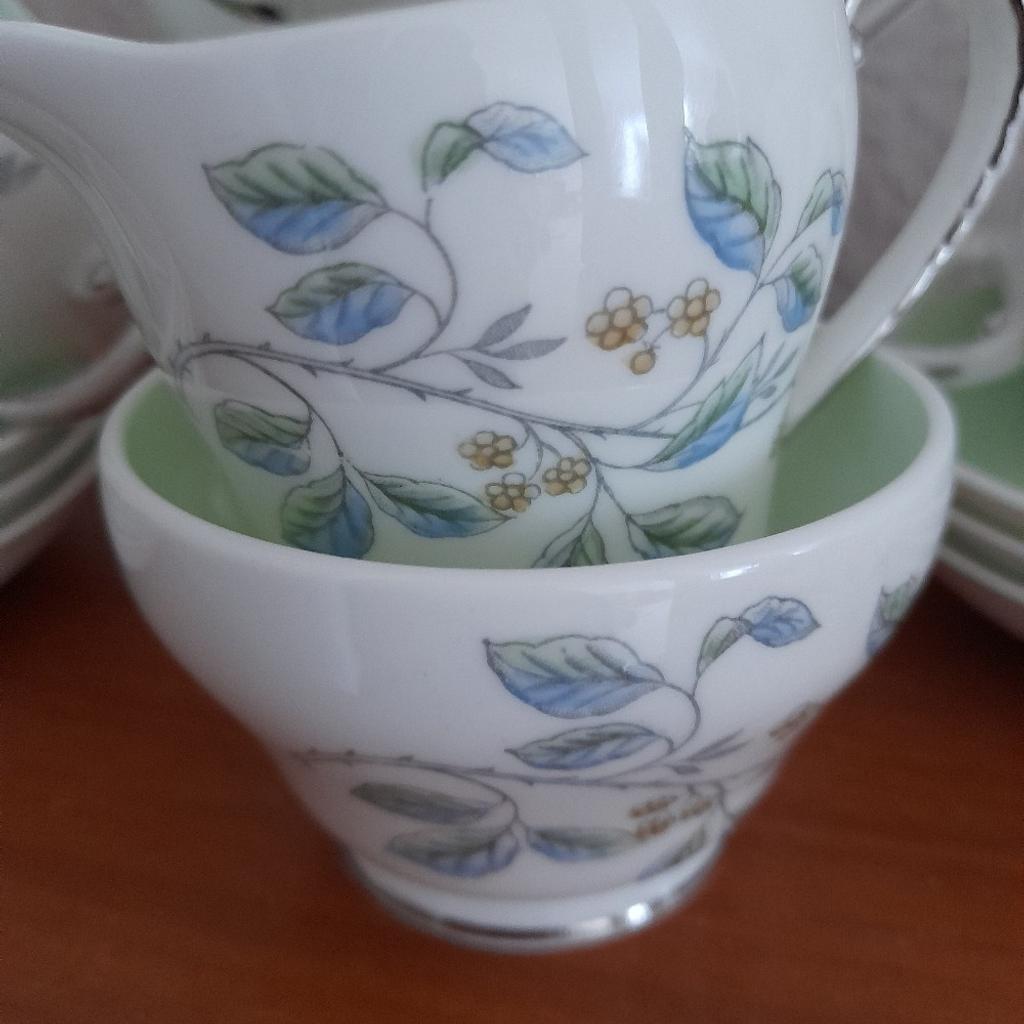 Vintage Royal Grafton Bone China Complete Coffee Set Immaculate Hardly Used Condition. 15 items, coffee pot with lid, cream/milk Jug, sugar bowl, 6 coffee cups and 6 saucers. White with silver trim, delicate blue green and silver floral/leaf decoration and pale green interiors. Absolutely gorgeous. Was a wedding present to my parents in 1962, family never big coffee drinkers hence the fabulous condition. Spent most of its life unused in a glass display cabinet. From smoke and pet free home. Check out my other items. Collection from DL5 only please due to risk of damage in transit. Thanks for looking.