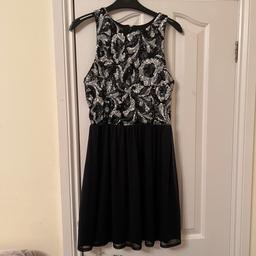 Black dress with silver and black sequins at the top.dress is soft and stretchy with zip fastening down the back.mesh fabric at the bottom with stretchy comfy fabric underneath.size 10 from Miss Selfridges in very good condition