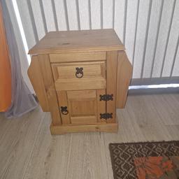 lovely side table with magazine holders on both sides. decent sized drawer and cupboard. few marks on top but in really good order. collection royston