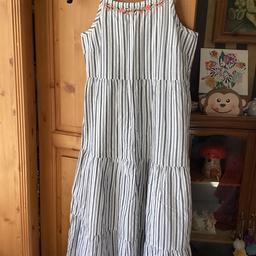 Beautiful girls maxi dress, has been washed but not worn.
White and blue stripe with a silver thread through. It has a under skirt too.