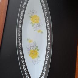 Pretty Glass Floral Platter Dish New unused, only ever been in glass display case. Was brought back from Germany as a gift in 1980s. Beautiful fine glass Platter white, with yellow flowers. A real quality vintage item, measures 13.5 inches x 5 inches. From smoke and pet free home, check out my other items. Happy to combine postage for multiple purchases when possible or collection from DL5. Thanks for looking.