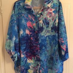 Stunning blue multi coloured silk look shirt. Can be worn fastened or open as a layering piece. Unusual. Size large to fit size 14 - 16. Smoke & pet free home. Fab with jeans or dressed up