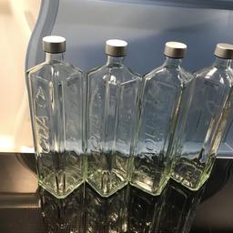 Large (750ml) Glass Bottles. Tall and square with gently angled edges and AQUA in relief on 2 sides. No labels or stickers. Lovely to use for water, oil or juice etc. Perhaps in the car when on the go or by the bed or as vases, olive oil etc. Could fill with seeds or lentils etc. Decorative. Useful. Approximately 27cm tall and 6.5cm on each side. Silver screwtop. Shape and moulding makes them easy to grip.
PRICE IS FOR 1 BOTTLE.
Square Glass Water 'Aqua' embossed Bottles (empty) 750ml capacity. Lovely!

Used once only. From a smokefree and petfree home.

I have more of these so do ask if you’d like more. I also have lots of 330ml size too. Postage is possible.