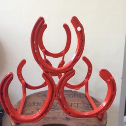 Handmade wine rack made from reclaimed authentic horseshoes. Using 6 horseshoes to make a tiered wine rack that will hold up to 3 bottles. Professionally powder coated in a Red satin finish.

Approx 29 cm H x 28cm W x 19cm D

Bottle not included.

Great item as a gift for a horse fanatic or quirky item for your own home decor.

Price includes free postal delivery