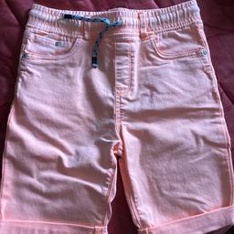 These are shocking orange soft denim shorts. Washed but not worn. Age 10