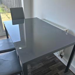 Dining table in very good condition. The four chairs have got wear and tear.