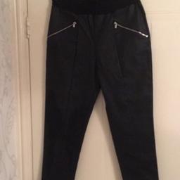 Stunning black faux leather trousers size 10. Faux zips at the front & working zips at bottom of trousers so cam adult the look. Like new worn once. On trend look. Elasticated waist so lots of stretch. Smoke & pet free home. Grab a bargain