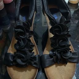 Black wedge sandals with roses, coming down the front sip up at the back side six