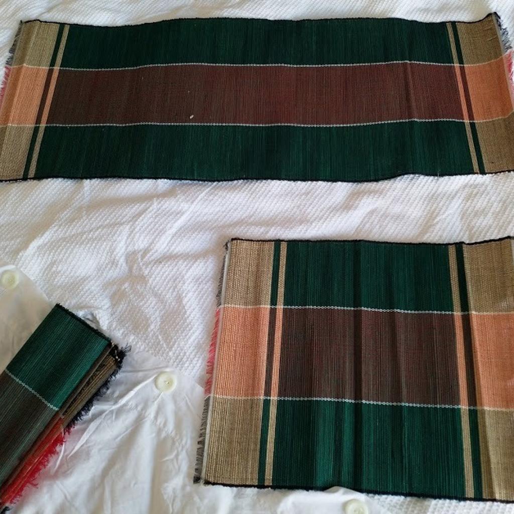 Set of 7 Green & Orange African Handwoven Table Placemats with Runner. Unique from Uganda. Runner measures 82cm wide x 32cm high and 6 x mats 37cm wide x 32cm. Lightweight and rolls to a small package for easy storage. Brand New.