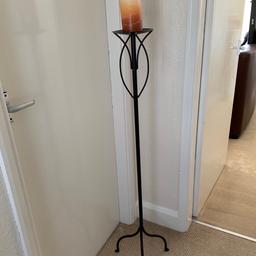 Black wrought iron long standing candle holder, good condition .