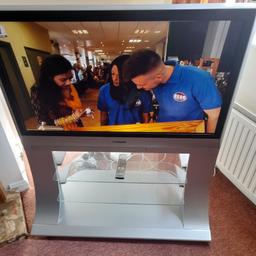 42 inch television with built in 2 shelf unit . remote control with manufacturers user manual