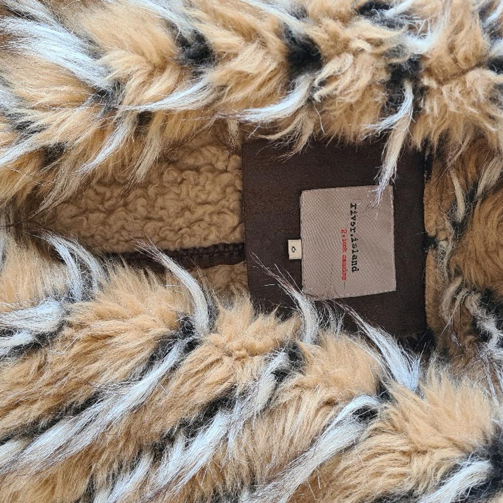 Beautiful River Island Faux Fur, Faux sheepskin and Faux leather jacket. 1st 2c. Uk size 6 in excellent condition. See photos for condition, flaws, size and materials. I can offer try before you buy option but if viewing on an auction site viewing STRICTLY prior to end of auction.  If you bid and win it's yours. Cash on collection or post at extra cost which is £4.55 Royal Mail 2nd class. I can offer free local delivery within five miles of my postcode which is LS104NF. Listed on five other sites so it may end abruptly. Don't be disappointed. Any questions please ask and I will answer asap.