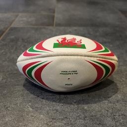 Mini Welsh rugby ball. Needs blowing up. Has some signed of use shown on pics.