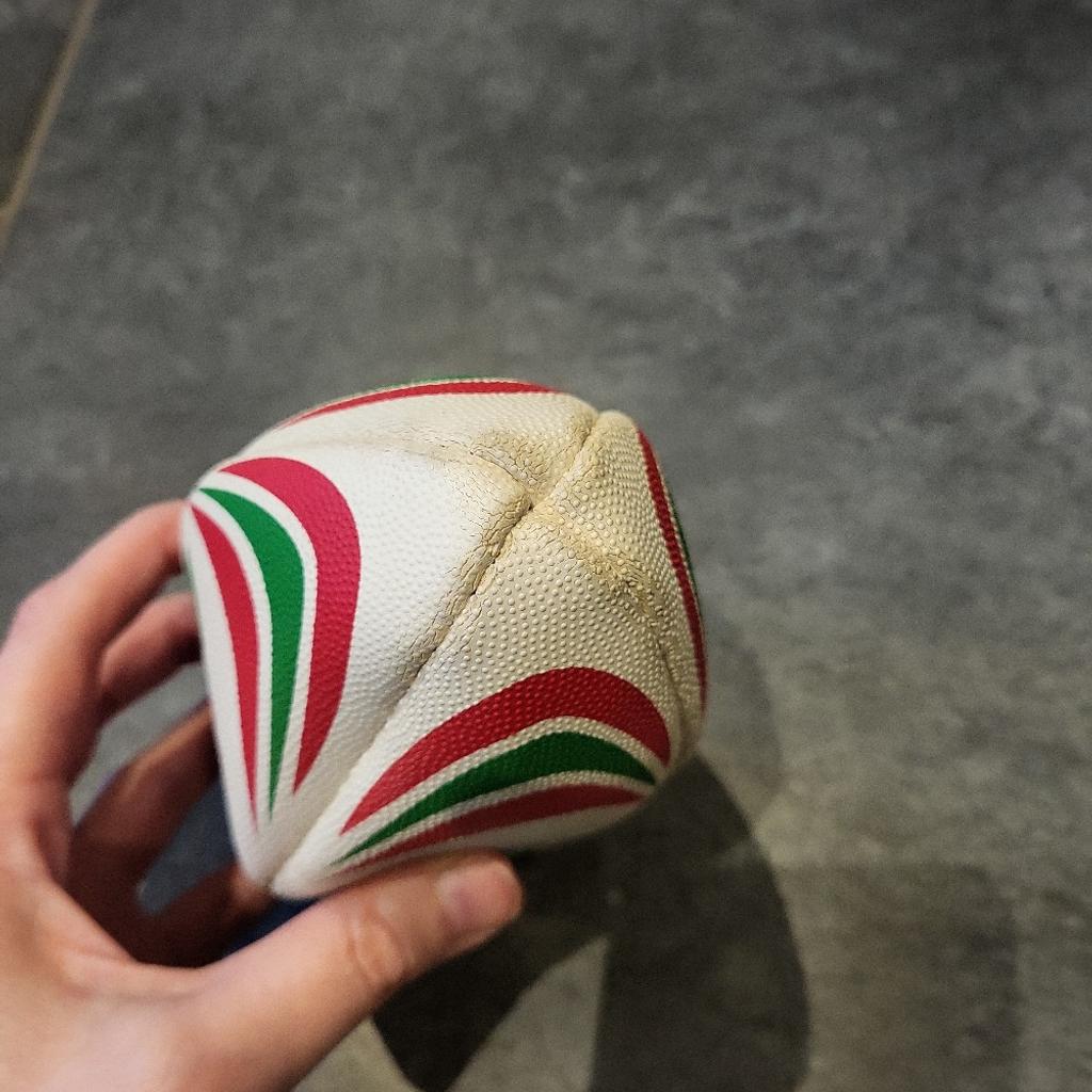 Mini Welsh rugby ball. Needs blowing up. Has some signed of use shown on pics.