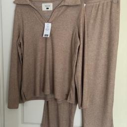 F&F ladies loungewear, comfortable loose fitting,size 12-14. Colour taupe. Top long sleeved, v neck with collar. Bottoms have elasticated waistband. Soft brushed material. New with tags
