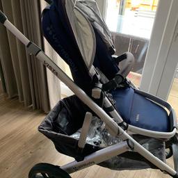 Uppababy Vista 2015 model Taylor (Indigo)

Newborn carrycot - barely used

Pushchair seat unit - A forward-facing or rear facing chair for when they get a little older and are able to sit up unaided (usually around 6 months plus). Well used but in great condition. Has a few scratches on the frame, does not effect the use. The sunshade attached to the buggy has a slight hole, picture attached.

Accessories - rain cover (for both carrycot and pushchair),insect net (for both carrycot and pushchair). Foot muff, bought from John Lewis (pictured - blue and white stars). Additional clip on sunshade.

Bag to use when storing

Does have the ability to attach a car seat to the buggy - adaptors included. We do have the baby car seat maxi cosí pebble that could be included if someone was interested.
In April 2023 went through an uppababy service so is fully working and any issues have been repaired. Documents can be sent as requested.
Please let me know if you’d like more pictures