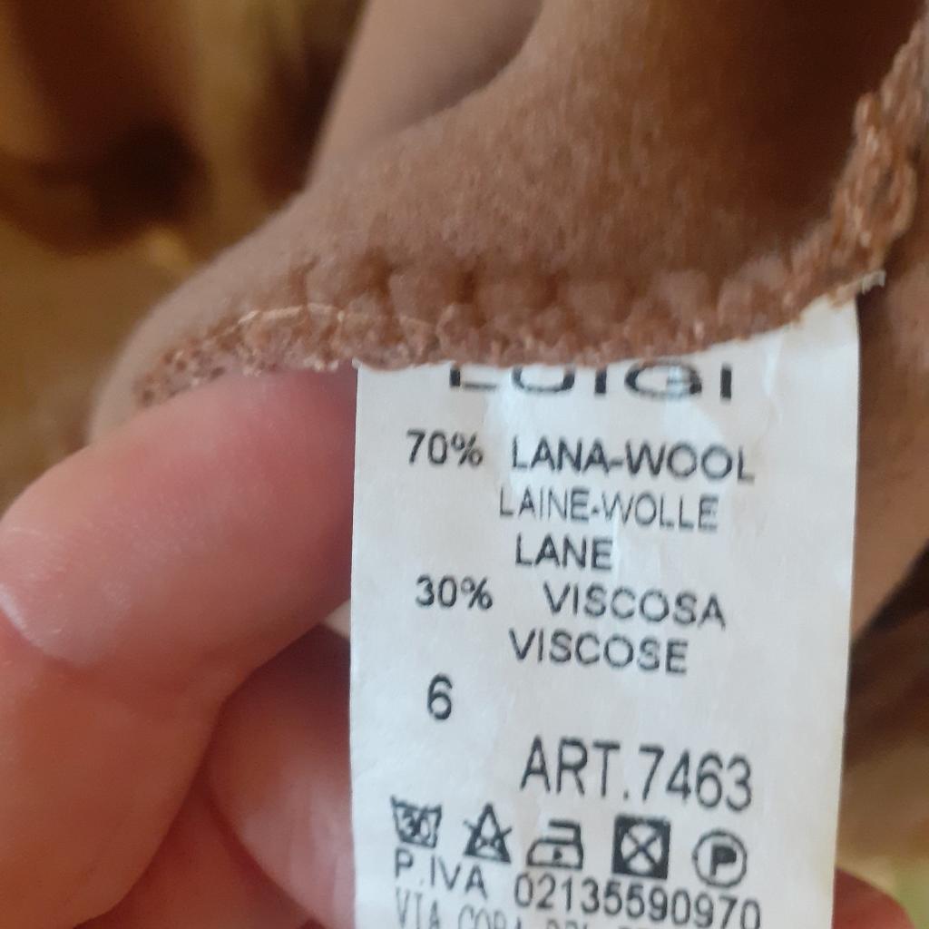 Cape coat made in Italy by LUIGI. Camel colour. Faux fur trim with hood. 69% lambs' wool and 30% viscose. Only worn a few times. Good Condition. Unlined. No size visible but easily fits a size 12 and probably more because of the design.