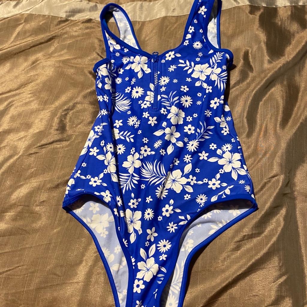 Girls swimsuit. Hardly worn but is used. Zip design on the front. From 915 range at New Look. Size 10-11. Collection only.