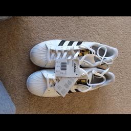 Adidas superstar original trainers
White  and black with gold label on tongue
New with tags
Size 8
From a pet and smoke free home