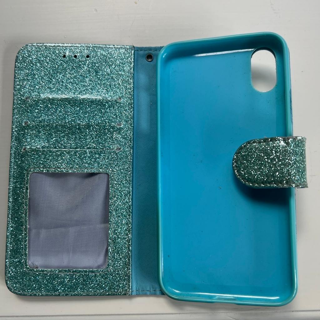 IPhone X (10) case in a Turquoise glitter finish with heart on the front. Magnetic clasp . Protect your phone from damage.Takes a picture and 3 Credit/Debit Cards