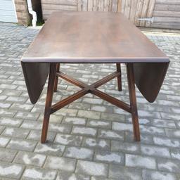Ercol drop leaf dining table having the early blue label and in good vintage used condition.